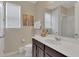 Clean bathroom with dark brown vanity, white countertop, and a large mirror at 1770 Sawyer Palm Pl, Kissimmee, FL 34747