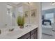 Double vanity bathroom with a view into a bedroom at 1770 Sawyer Palm Pl, Kissimmee, FL 34747