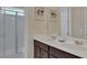 Bathroom with double vanity, large mirror, and walk-in shower at 1770 Sawyer Palm Pl, Kissimmee, FL 34747