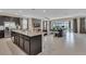 Open kitchen with an island, granite countertops, and views to the living room at 1770 Sawyer Palm Pl, Kissimmee, FL 34747