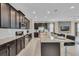 Modern kitchen with dark cabinetry, granite countertops, and stainless steel appliances at 1770 Sawyer Palm Pl, Kissimmee, FL 34747