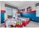 ' bedroom with twin beds, superhero bedding, and blue walls at 1754 Caribbean View Ter, Kissimmee, FL 34747