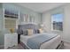 Bedroom with king bed, gray headboard, and teal accent wall at 1754 Caribbean View Ter, Kissimmee, FL 34747