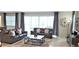 Spacious living room with gray leather sofas, a large TV, and access to the pool area at 1754 Caribbean View Ter, Kissimmee, FL 34747