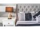 White nightstand with a lamp and decorative accents at 1754 Caribbean View Ter, Kissimmee, FL 34747
