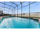 Screened-in saltwater pool with a tranquil view at 1754 Caribbean View Ter, Kissimmee, FL 34747