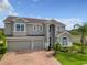 Two-story house with gray siding, two car garage, and a brick driveway at 14523 Black Lake Preserve St, Winter Garden, FL 34787