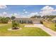 Lovely ranch-style home with a circular driveway and manicured lawn at 720 Shore Drive, Kissimmee, FL 34744