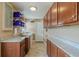 Convenient laundry room with ample storage and granite countertops at 720 Shore Drive, Kissimmee, FL 34744