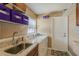 Laundry room with washer, dryer, utility sink, and ample shelving at 720 Shore Drive, Kissimmee, FL 34744