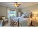 Charming bedroom with a queen-size bed and wicker furniture at 720 Shore Drive, Kissimmee, FL 34744