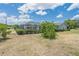 Landscaped backyard with pool and enclosure at 720 Shore Drive, Kissimmee, FL 34744