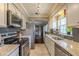 Modern kitchen with stainless steel appliances, granite countertops and ample cabinet space at 720 Shore Drive, Kissimmee, FL 34744