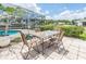 Enjoy outdoor dining on this patio with seating for four and a view of the pool at 720 Shore Drive, Kissimmee, FL 34744