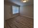 Bright entryway with wood-look floors and white door at 714 Siena Palm Dr # 203, Celebration, FL 34747