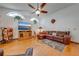 Spacious living room with hardwood floors and a large sectional sofa at 4450 Kaiser Ave, St Cloud, FL 34772