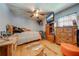 Rustic bedroom with wood floors and a large ceiling fan at 4450 Kaiser Ave, St Cloud, FL 34772