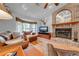 Living room with leather furniture, brick fireplace, and hardwood floors at 4450 Kaiser Ave, St Cloud, FL 34772