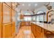 Kitchen with wood cabinets, granite countertops, and stainless steel appliances at 4450 Kaiser Ave, St Cloud, FL 34772