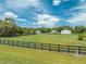 View of house and barn with large fenced pasture, showcasing the property's rural setting at 4450 Kaiser Ave, St Cloud, FL 34772