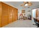 Bright bedroom featuring wood closet doors and ceiling fan at 4450 Kaiser Ave, St Cloud, FL 34772