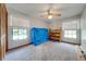 Spacious bedroom with large windows, ceiling fan, and carpeted floor at 4450 Kaiser Ave, St Cloud, FL 34772