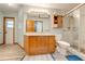Updated bathroom with wood vanity, large mirror and walk-in shower at 4450 Kaiser Ave, St Cloud, FL 34772