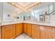 Spacious bathroom with double sinks, wood cabinets, and a corner vanity at 4450 Kaiser Ave, St Cloud, FL 34772