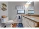 Updated bathroom with granite countertops and a modern toilet at 4450 Kaiser Ave, St Cloud, FL 34772