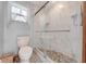 Clean bathroom with toilet and a walk-in shower with pebble floor at 4450 Kaiser Ave, St Cloud, FL 34772
