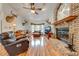 Spacious living room with hardwood floors and a brick fireplace at 4450 Kaiser Ave, St Cloud, FL 34772