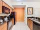 Modern kitchen with black appliances and wood cabinets, offering great workspace at 8125 Resort Village Dr # 51104, Orlando, FL 32821
