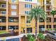 Building entrance with palm trees and parking at 8125 Resort Village Dr # 51104, Orlando, FL 32821