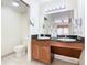 Double vanity bathroom with granite countertop and toilet at 8125 Resort Village Dr # 51104, Orlando, FL 32821