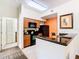 Modern kitchen with dark wood cabinets and black appliances at 8125 Resort Village Dr # 51104, Orlando, FL 32821