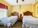 Guest bedroom with two twin beds and a ceiling fan at 8125 Resort Village Dr # 51104, Orlando, FL 32821