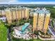 Aerial view of a luxury condo complex with a large pool and surrounding landscape at 8125 Resort Village Dr # 51104, Orlando, FL 32821