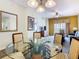 Dining area featuring a glass-top table and chairs, offering views of living room and balcony at 8125 Resort Village Dr # 51104, Orlando, FL 32821