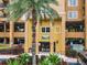 Building entrance with palm trees and parking at 8125 Resort Village Dr # 51104, Orlando, FL 32821