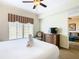 King bedroom with large windows and a ceiling fan at 8125 Resort Village Dr # 51104, Orlando, FL 32821
