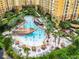 Large resort pool with pirate ship, multiple lounge areas, and palm trees at 8125 Resort Village Dr # 51104, Orlando, FL 32821