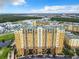 Aerial view of an apartment building near a lake at 8125 Resort Village Dr # 51104, Orlando, FL 32821