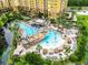 Resort pool with pirate ship water feature, lounge chairs, and palm trees at 8125 Resort Village Dr # 51104, Orlando, FL 32821