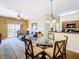 Bright dining area with glass-top table and four chairs, adjacent to kitchen and living room at 8125 Resort Village Dr # 51104, Orlando, FL 32821
