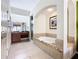 Elegant bathroom featuring a soaking tub, double vanity, and a walk-in shower at 8125 Resort Village Dr # 51104, Orlando, FL 32821