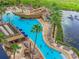 Resort-style pool with pirate ship water feature, multiple buildings, and lush landscaping at 8125 Resort Village Dr # 51104, Orlando, FL 32821