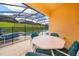 Screened patio with pool, lounge chairs, and patio furniture at 8612 La Isla Dr, Kissimmee, FL 34747