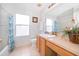 Clean bathroom with light wood vanity and a shower/tub combo at 8612 La Isla Dr, Kissimmee, FL 34747