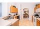 Bright kitchen with ample cabinetry, double sink, and view to dining area at 8612 La Isla Dr, Kissimmee, FL 34747