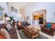 Open living room with high ceilings, leather furniture, and kitchen view at 8612 La Isla Dr, Kissimmee, FL 34747
